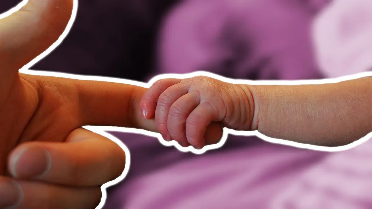 Parent holding a child's finger